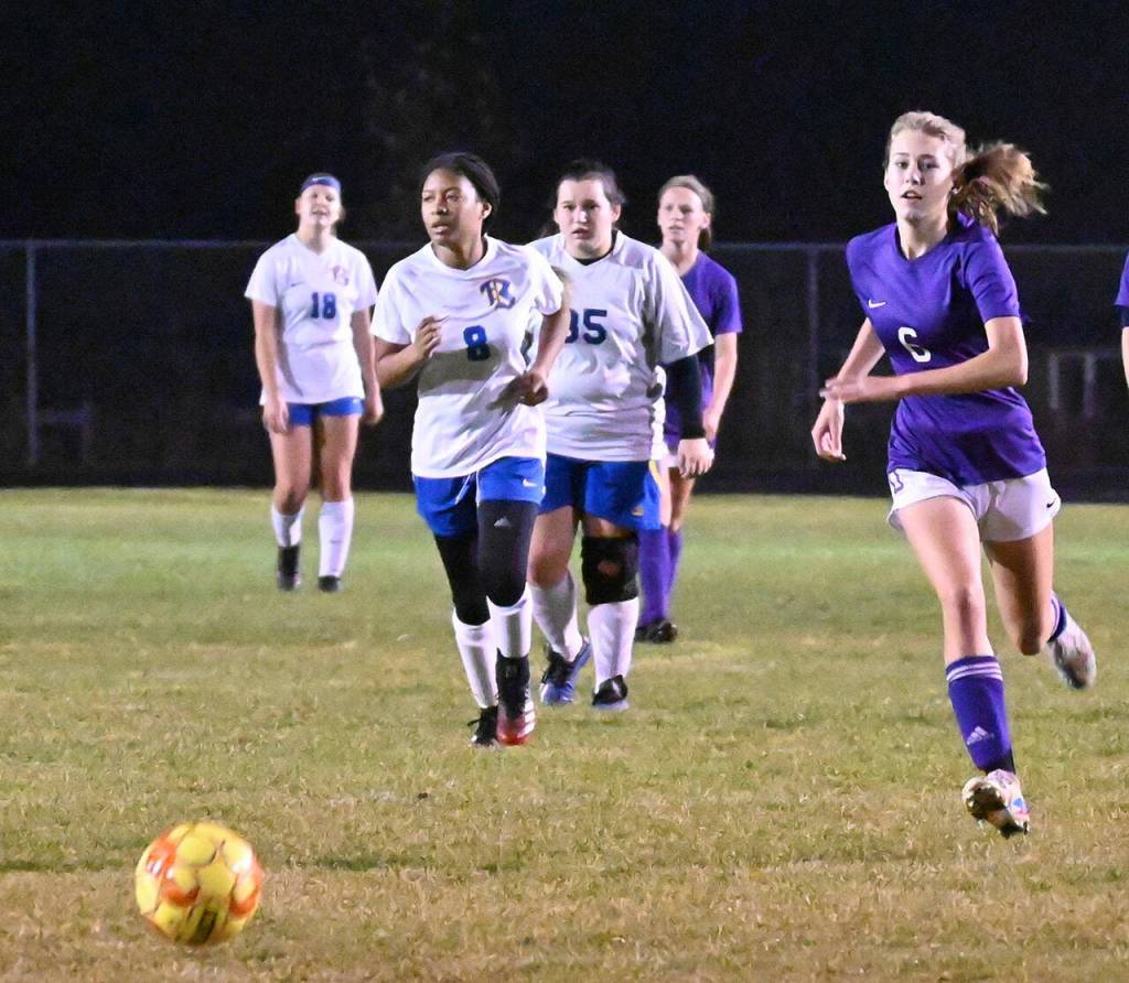 Sequims Teagen Moore, right, chases down a ball deep in Bremerton territory in the Wolves 6-0 win over the visiting Knights on Oct. 19. Sequim Gazette photo by Michael Dashiell
