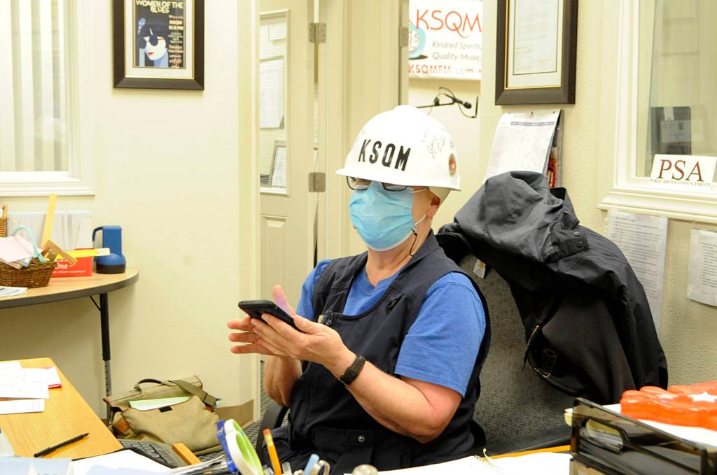 Linda Johannessen, a KSQM volunteer Jill-of-all-trades, checks information on her phone just prior to the Great Washington Shakeout on Oct. 21. Sequim Gazette photo by Matthew Nash
