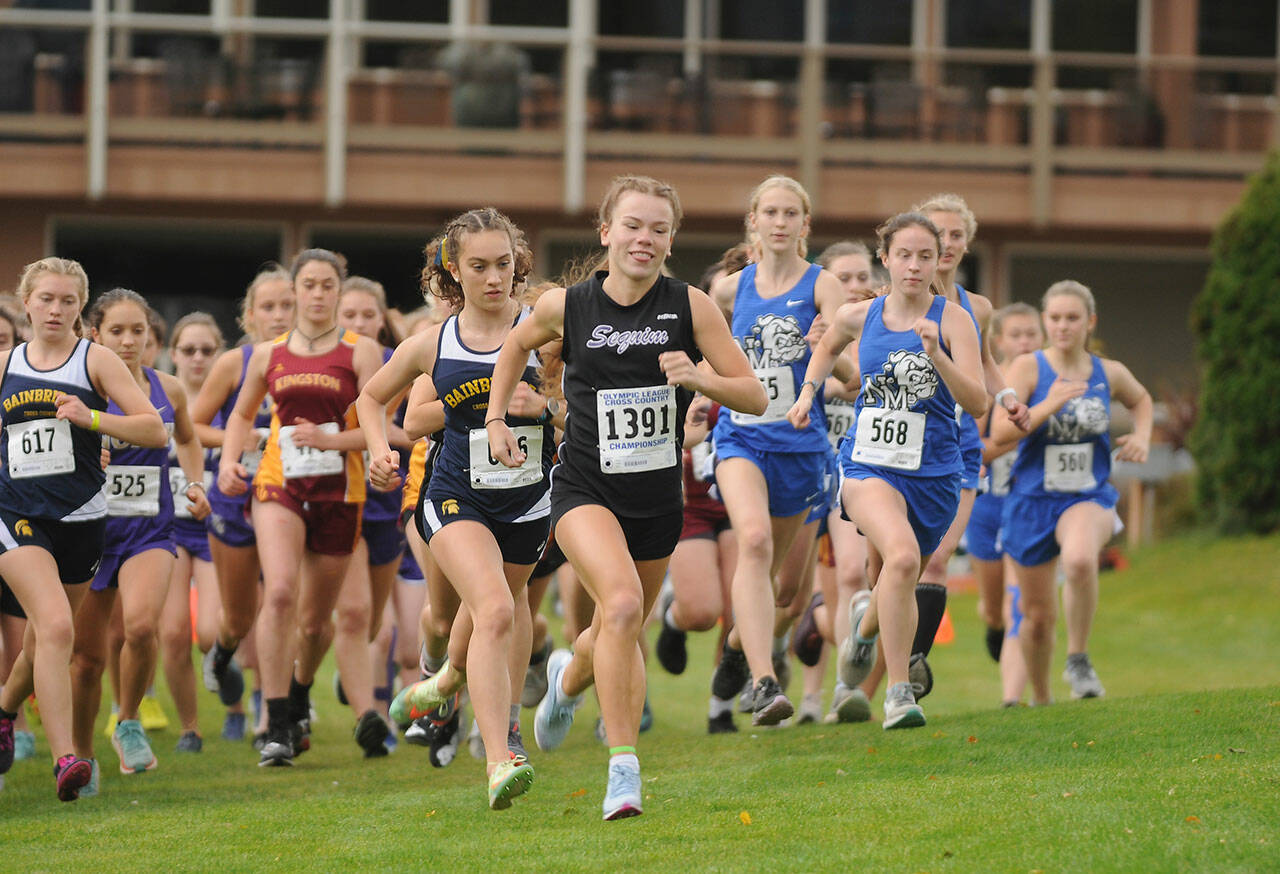 Sequim High senior Riley Pyeatt breaks from the starting line and leads the Olympic League championship race from start to finish. Shell be a favorite among the top runners at the West Central District meet on Oct. 30. Sequim Gazette photo by Michael Dashiell