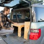 Steve Moore demonstrates two products of Camp N Car (a Port Townsend company begun by two Sequim High graduates in 2019), the Trunk Bunk and Van Shelf. Sequim Gazette photos by Emily Matthiessen