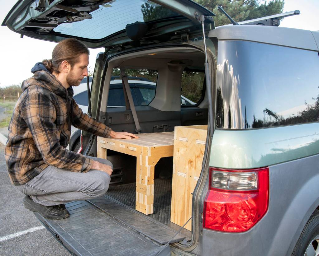Steve Moore demonstrates two products of Camp N Car (a Port Townsend company begun by two Sequim High graduates in 2019), the Trunk Bunk and Van Shelf. Sequim Gazette photos by Emily Matthiessen