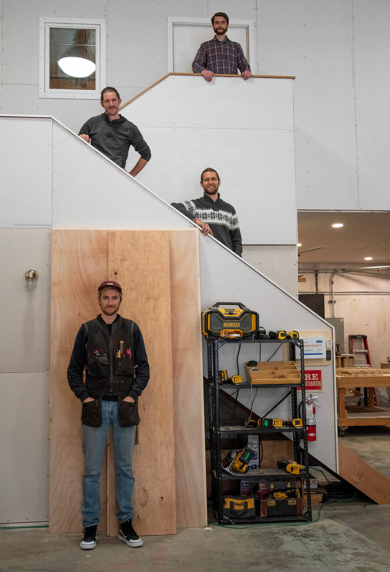 Four of the six member team of Camp N Car pose on the stairs to the office of their shop in Port Townsend. Sequim Gazette photo by Emily Matthiessen