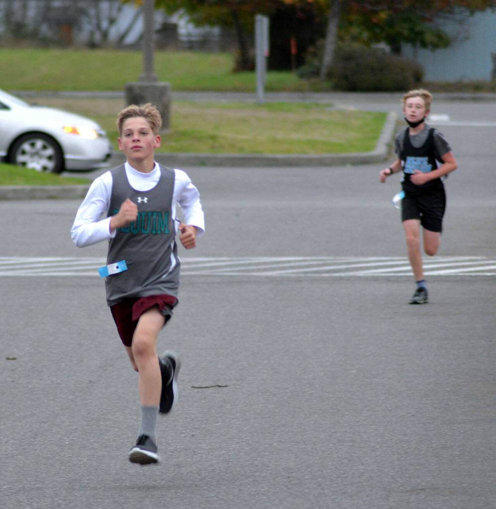 At left, Bjorn Henrikson races to a third-place finish at the Olympic League middle school championships on Oct. 20 at Lincoln Park. Photo courtesy of Caleb Gentry