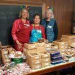 Guild members (from left) Robbie Justyn, Renee Jones and Elaine OBrien help customers at the bake table at the Sequim Guild of Seattle Childrens Hospitals annual bazaar in 2019. Submitted photo