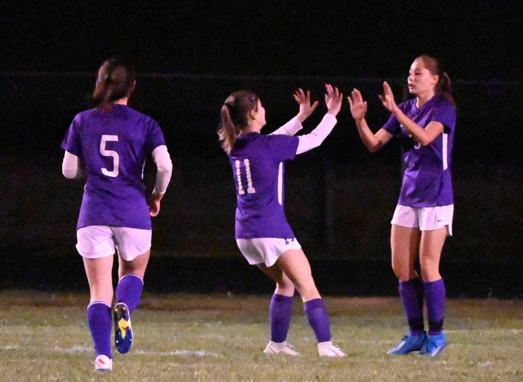 Sequim teammates Kariya Johnson (5) and Alliyah Weber celebrate a first-half goal by Taryn Johnson as the Wolves take on North Mason on Oct. 27. Sequim Gazette photo by Michael Dashiell
