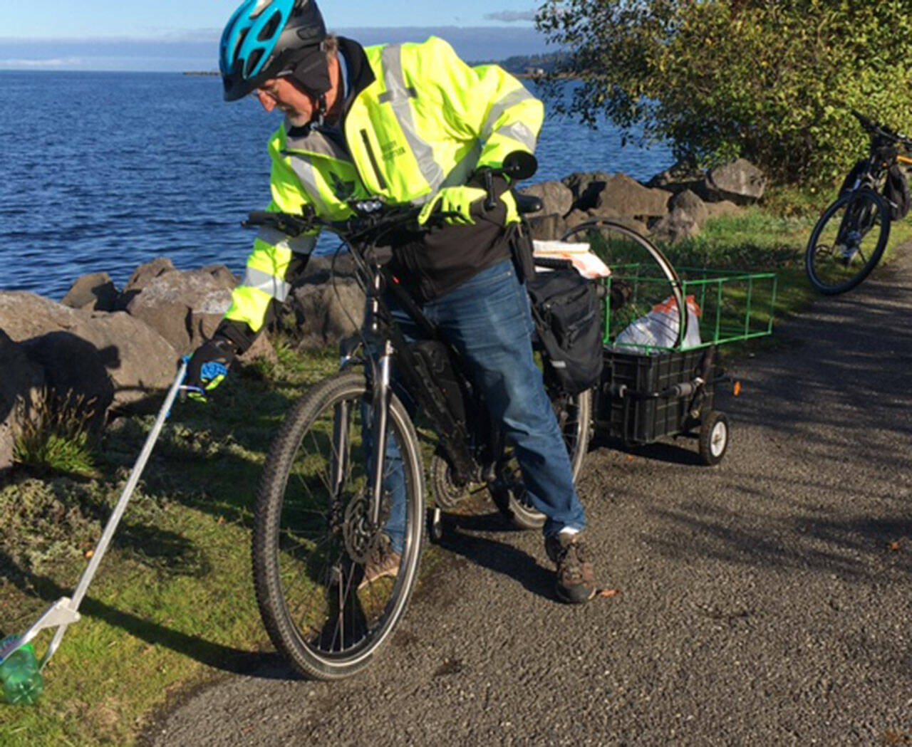Alan Barnard helps pick up trash along the Waterfront Trail. Photo courtesy of Clallam County Sheriffs Office