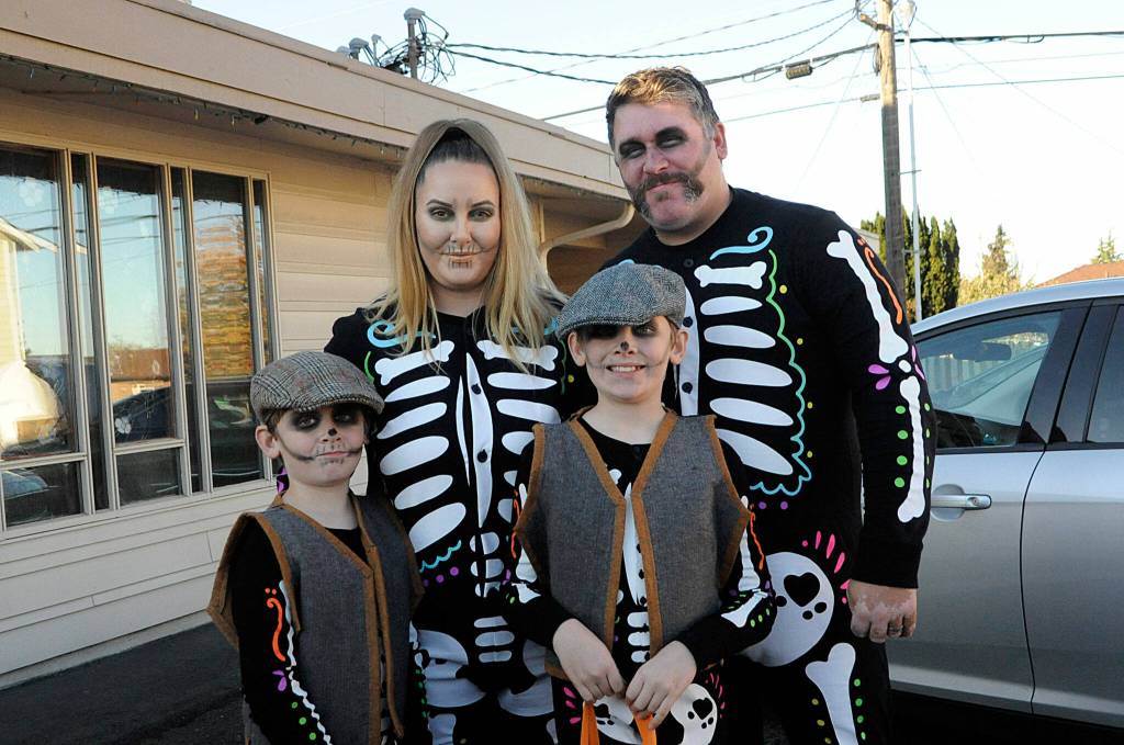 Above: The Tangedahl family skeleton crew of Heather, Matt, Dean, 6, and Aiden, 9, go on a trunk-or-treat on Halloween at Faith Lutheran Church. 
Bottom center: The Henry family represents their Pac Man fever at Thrive Churchs Trunk-or-Treat on Halloween, with family members, from left, Luke, 13, Haddie, 16, Lydia, 4, Kendra and Brian.