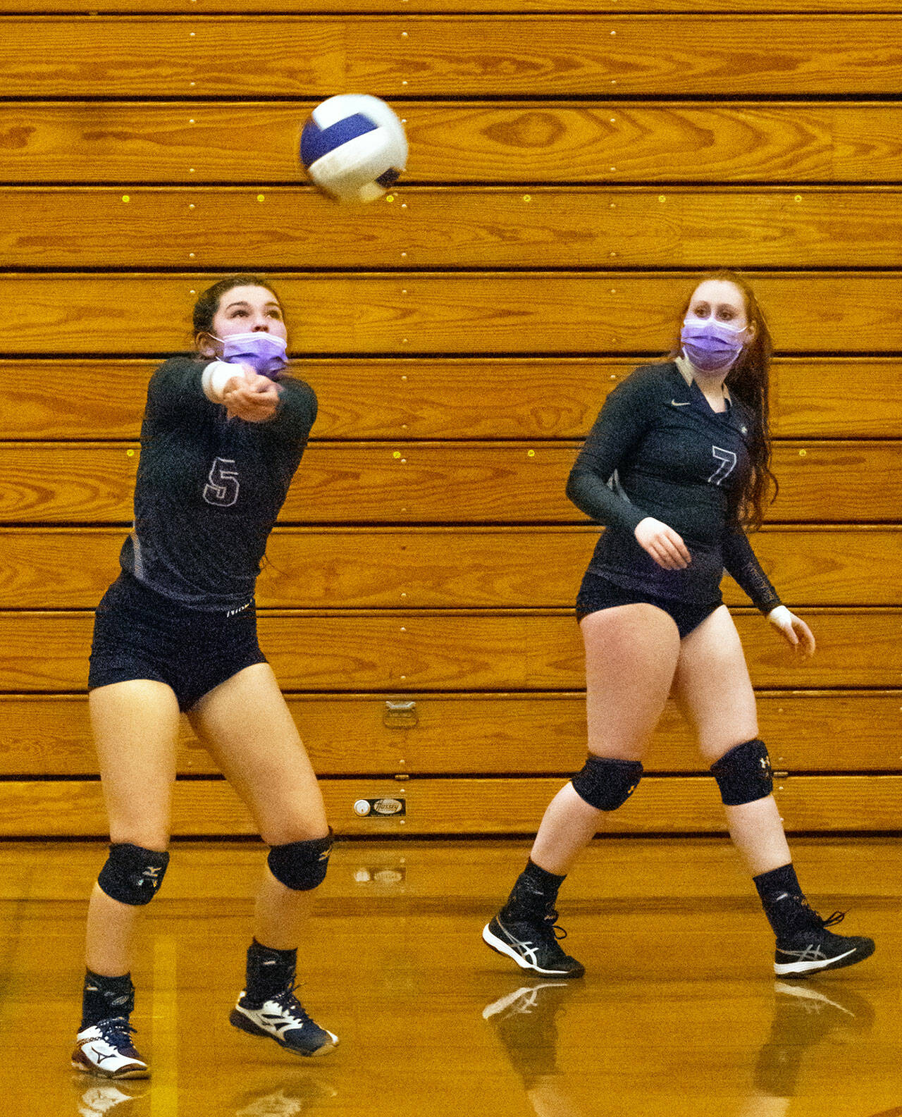 As teammate Kelsi Bergeson looks on, Sequims Allie Gale bumps a pass in the Wolves 3-1 win over Kingston on Nov. 2. With the win, Sequim advanced to the Olympic League seeding tourney final against North Kitsap. Sequim Gazette photo by Emily Matthiessen