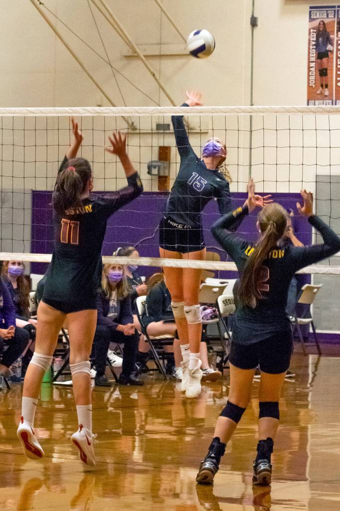 Sequims Kendall Hastings, center, looks to put a spike past the block attempts of Kingstons Marion Stejer (11) and Eva Stejer (2) in the Wolves 3-1 win over Kingston on Nov. 2. Sequim Gazette photo by Emily Matthiessen