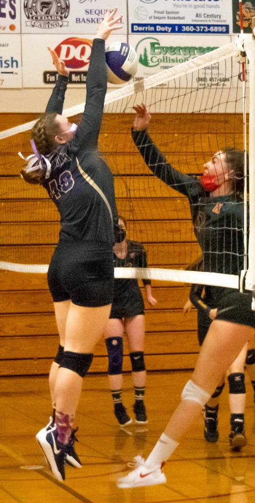 Sequims Malory Morey, left, blocks a Kingston spike attempt on Nov. 2. Sequims Wolves topped the Buccaneers 3-1 in the Olympic League seeding tournament semifinal. Sequim Gazette photo by Emily Matthiessen