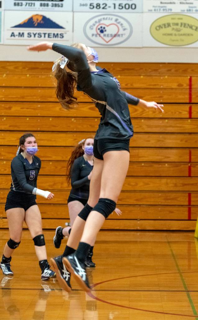 As teammates Allie Gale, left, and Kelsi Bergeson look on, Sequims Jolene Vaara rises up for a hit in the Wolves 3-1 win over Kingston on Nov. 2. Sequim Gazette photo by Emily Matthiessen