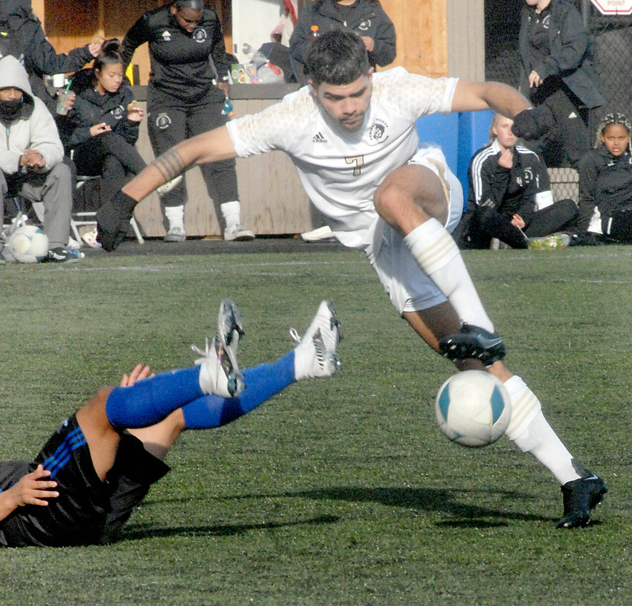 Peninsulas Jonathan DeMotta barrels over Rogues Jose Gallegos on Nov. 6 at Wally Sigmar field in Port Angeles. Photo by Keith Thorpe/Olympic Peninsula News Group