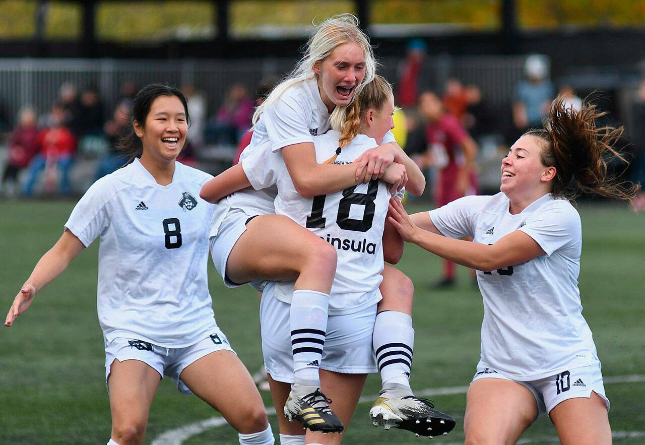 Millie Long, a Port Angeles High graduate, celebrates a goal with Peninsula College teammates Chiaki Takase (8), Kyrsten McGuffey (18) and Grace Johnson (10) in the Pirates 4-0 win over Pierce Saturday in an NWAC quarterfinal match-up. Photo by Jay Cline