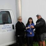 Sequim Food Bank leaders, executive director Andra Smith, on left, and volunteer Stephen Rosales, right, hand the keys of the facilitys longtime delivery truck to Mary Budke, executive director of the Boys & Girls Clubs of the Olympic Peninsula on Nov. 8. Budke said theyll use it to pickup large donations and transfer items between the Sequim and Port Angeles units. Sequim Gazette photo by Matthew Nash