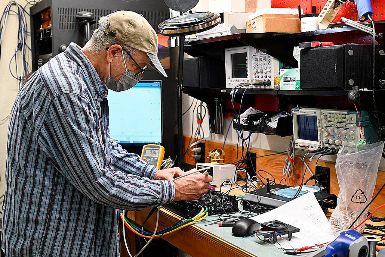 Robert Zeff, owner and CEO of Nikola Broadband/Nikola Engineering, troubleshoots a 1200W audio amplifier on the bench. Photo by Richard Greenway