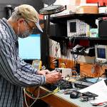 Robert Zeff, owner and CEO of Nikola Broadband/Nikola Engineering, troubleshoots a 1200W audio amplifier on the bench. Photo by Richard Greenway