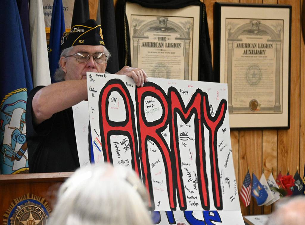 Carl Bradshaw, 1st Vice Commander American Legion Jack Grennan Post No. 26 in Sequim, displays some banners honoring the branches of the U.S. Armed Forces that were made by Sequim Middle School students. Sequim Gazette photo by Michael Dashiell