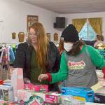 Volunteer Kirsti Turella helps mom Desirae Cortez look for just the right toy for her children in 2020 at Toys for Sequim Kids. The Sequim Community Aid sponsored event takes place Dec. 15 at Sequim Prairie Grange. Sequim Gazette file photo by Matthew Nash