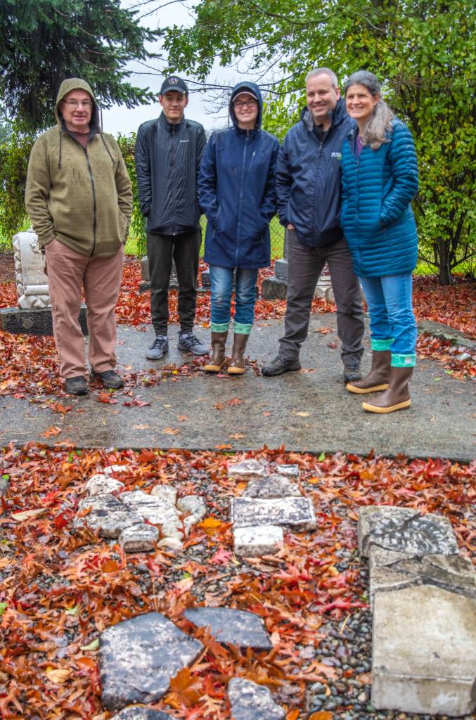 Right: Pieces of Civil War veteran Moore Waldrons headstone can be seen in the right-hand corner of this photograph. Historical preservationist Mick Hersey, left, and the Taylor family of Gig Harbor returned the pieces to the Pioneer Memorial Park of Sequim for their friends the Englands (Moores descendants). The Englands read in the Sequim Gazette about the Sequim Garden Clubs preservation efforts at the park and decided to return these pieces for restoration. Moore now will have two markers in the park, as the Veterans Administration commissioned a new stone for Waldron in 2017  an article about which can also be found on the Sequim Gazetttes website. Moore moved to Sequim with his family in 1905 and died in 1908. Moore had five children and has descendants in Sequim and Pierce County as well as other places. Moores great-grandson is the founder of the Waldron Endoscopy Center in Tacoma, according to Cheryl England. Sequim Gazette photo by Emily Matthiessen