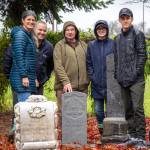 The Taylor family and Mick Hersey (center) stand behind Moore Waldrons new headstone in the Pioneer Memorial Park. Sequim Gazette photo by Emily Matthiessen
