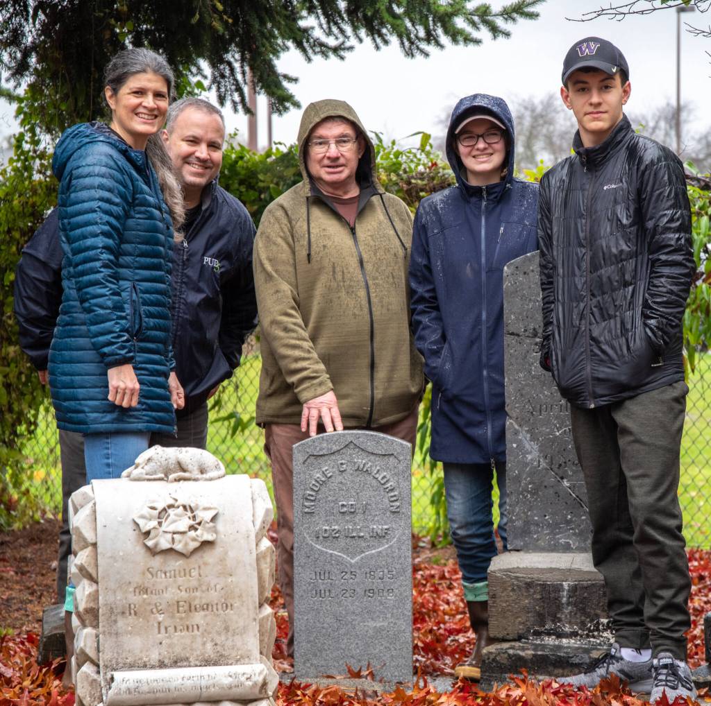 The Taylor family and Mick Hersey (center) stand behind Moore Waldrons new headstone in the Pioneer Memorial Park. Sequim Gazette photo by Emily Matthiessen