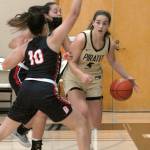 Peninsulas Hope Glasser, a Sequim High grad, right, fends of the defense of Bellevues Mo Bungay, front, and Mckayla Rodriguez during the Pirates 2020-2021 campaign. Glasser is one of six local products on the PC roster this season. File photo by Keith Thorpe/Olympic Peninsula News Group
