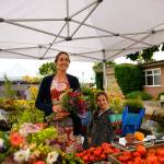 Marina Shipovas photograph of vendors at the Jembe Farms booth at the Sequim Farmers & Artisans Market is one of a series the peninsula photographer created as part of the Sequim Understory Project. Shipova will be outside the Sequim Civic Center from 1-3 p.m. Saturday, Nov. 27, as a part of the Art Beat event. Photo by Marina Shipova