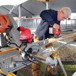 Steve Hargis cuts pieces on Wednesday, Nov. 17, for a viewing platform for ice skaters at the Port Angeles Winter Ice Village. Photo by Keith Thorpe/Olympic Peninsula News Group