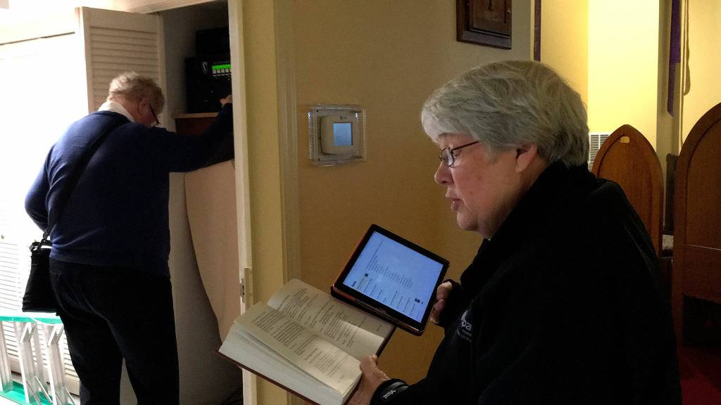 Deacon Lani Hubbard, left, with St. Lukes Episcopal Church rings the churchs bell on March 14, 2018, one time for each victim of the Parkland, Fla., school shooting on Feb. 14, while Sherry Niermann reads the victims names and says a prayer for each one. Sequim Gazette file photo by Matthew Nash
