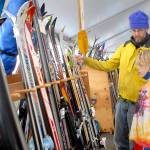 Ned Hammar of Port Angeles and his son, Felix Lubinski Hammar, 9, examine a rack of snow skies during the Winterfest ski swap in the Black Ball Ferry parking lot on the Port Angeles waterfront on Nov. 20. The event, a fundraiser for the Hurricane Ridge Winter Sports Club, featured a variety of skis, snowboards and related sports gear. Photo by Keith Thorpe/Olympic Peninsula News Group