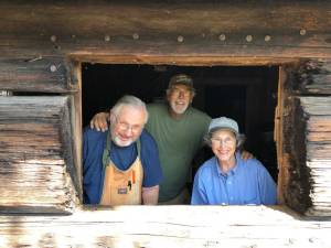 Sequim Prairie Garden Club volunteers stand inside a log cabin donated to the Sequim Prairie Garden Club and Pioneer Memorial Park in 1965 but dates back to 1893. Volunteers have added windows to the structure to help visibility in the storage shed. Submitted photos