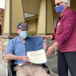 Sequims Frank Meek, a 96-year-old World War II veteran (U.S. Navy) receives a National Society of the Daughters of the American Revolution thank you for your service certificate outside Avamere Olympic Rehabilitation of Sequim in November. Submitted photo