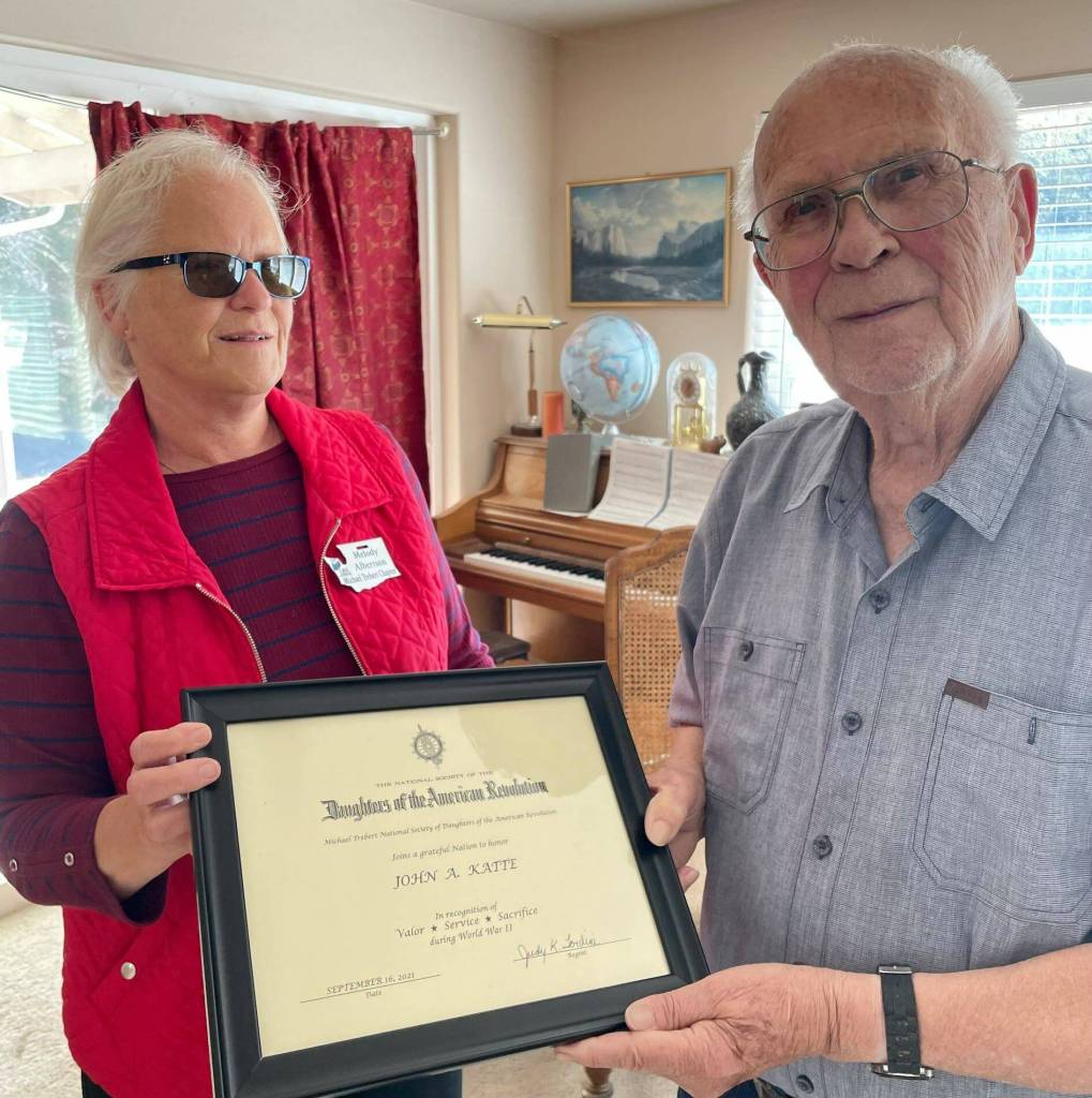 World War II veteran John A. Katte, 95, of Sequim, receives a commemorative National Society of the Daughters of the American Revolution thank you for your service certificate from Melody Albertson, Michael Trebert Chapter Chair of National Defense. Submitted photo