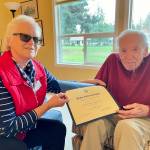 World War II veteran Caleb Cal Murphy, 102, receives a commemorative National Society of the Daughters of the American Revolution thank you for your service certificate. Submitted photo