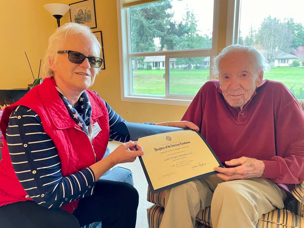 World War II veteran Caleb Cal Murphy, 102, receives a commemorative National Society of the Daughters of the American Revolution thank you for your service certificate. Submitted photo