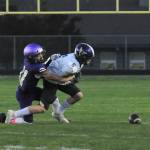 Sequim quarterback Lars Wiker, left, tries to avoid the grasp of a Bremerton defender in the Wolves 35-29 loss at Bremerton on Sept. 30. Sequim Gazette photo by Michael Dashiell