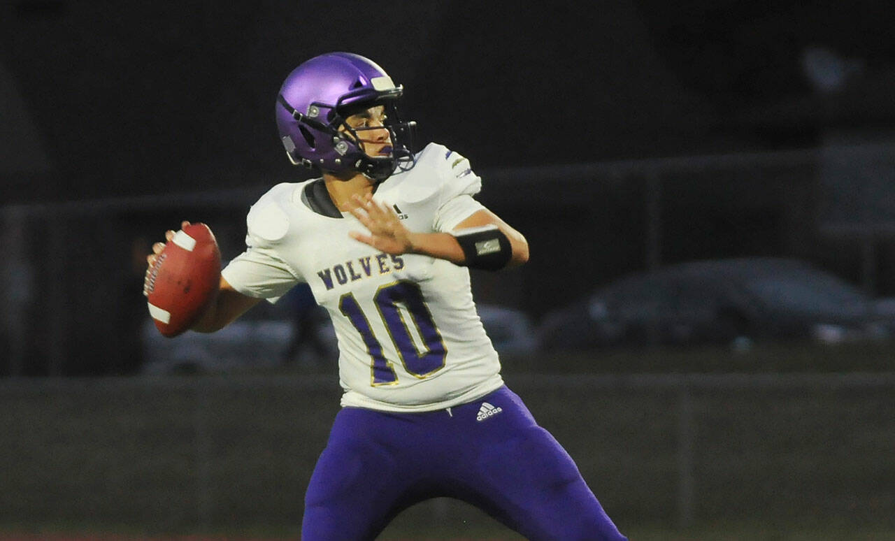 Sequim quarterback Lars Wiker looks for a receiver in the first half of the Wolves 35-29 loss at Bremerton on Sept. 30. Wiker had three touchdown passes. Sequim Gazette photo by Michael Dashiell