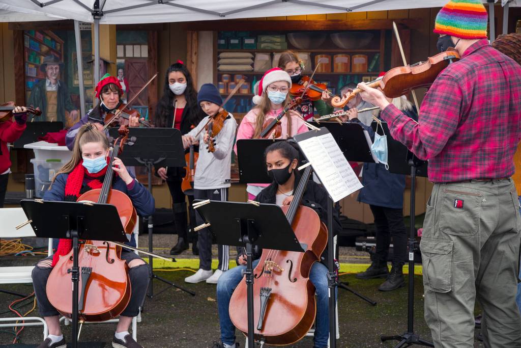 Members of Sequim Community Orchestra played holiday favorites at Home Town Holidays in Centennial Place with youth from their Strings Program. Strings instructor Teresa Herman teaches violin, viola, cello and base to local children under the auspices of the Orchestra. Sequim Gazette photo by Emily Matthiessen