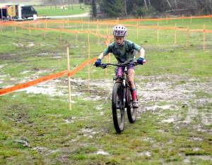 Eleanor Jones of Sequim races through a muddy bog at the Extreme Sports Park in Port Angeles on Nov. 28, as she competes in the the inaugural Extreme CX Port Angeles cyclocross event. Cyclocross, a popular sport in Europe, requires competitors to ride through mud, up steep hills and over obstacles and stairs. Riders often have to pick up their bikes and carry them through portage areas where the obstacles are too steep or the mud too slick to ride through. Riders from as young as 10 to as old as 65-plus competed in the late November event, with 94 riders on Nov. 27 and 104 riders the following day. Photo by Keith Thorpe/Olympic Peninsula News Group