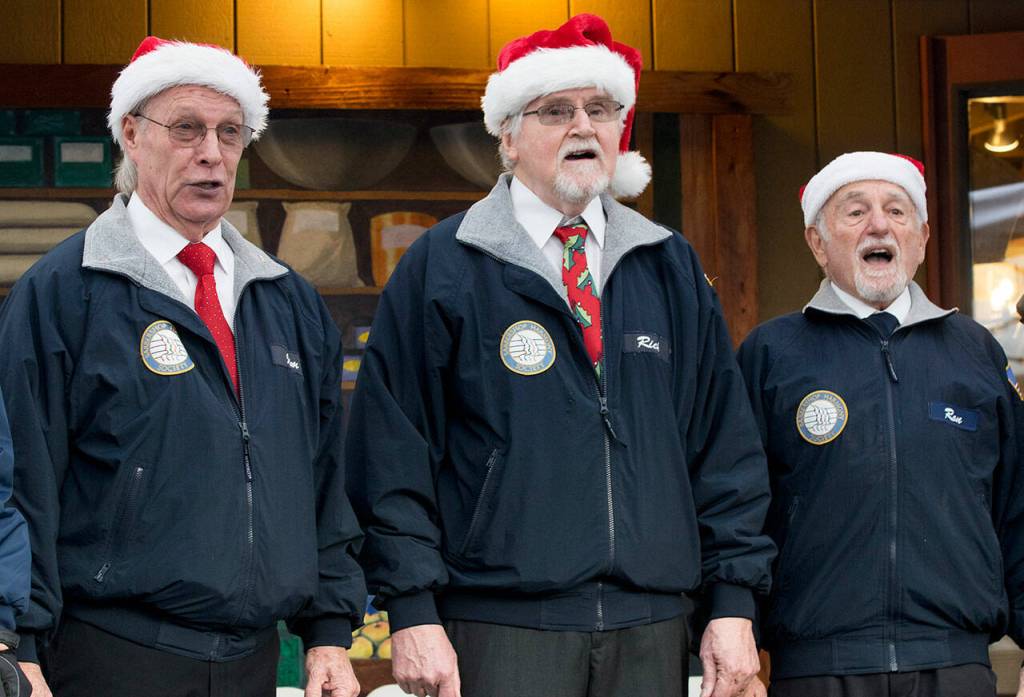 Member of the Olympic Peninsula Mens Chorus belt out a holiday favorite to locals and visitors participating in the Home Town Holidays celebration at Centennial Place on the corner of Washington Street and Sequim Avenue. Sequim Gazette photo by Emily Matthiessen