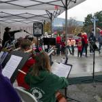 Teresa Herman leads young members of the Sequim City Orchestras Strings Program in a performance of classic holiday music as Santa meets members of the crowd at Home Town Holidays. Sequim Gazette photo by Emily Matthiessen