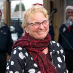 Author Heidi Hansen beams after receiving a round of Happy Birthday from the crowd led my members of the Olympic Peninsula Mens Chorus at Home Town Holidays in downtown Sequim. Sequim Gazette photo by Emily Matthiessen