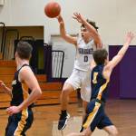 Sequim senior Tyler Mooney passes to a teammate in the Wolves 65-45 win over Forks on Dec. 3 to open the 2021-2022 season. Mooney had a game-high 21 points. Sequim Gazette photo by Michael Dashiell
