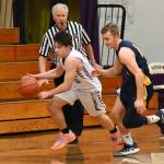 Sequim senior guard Jayden Possin, left, tries to sprint past Forks Logan Olson in the Wolves 65-45 win on Dec. 3. Sequim Gazette photo by Michael Dashiell