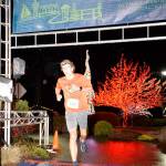 Sequim teen Colby Ellefson crosses the finish line first in the Jamestown SKlallam Glow Run 5k race on Dec. 4. Photo courtesy of Run the Peninsula
