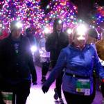 Sarah Bacica, No. 196, of Sequim leads a group of runners to the finish line at the Jamestown S'Klallam Glow Run on Saturday night in Blyn. (Run the Peninsula)