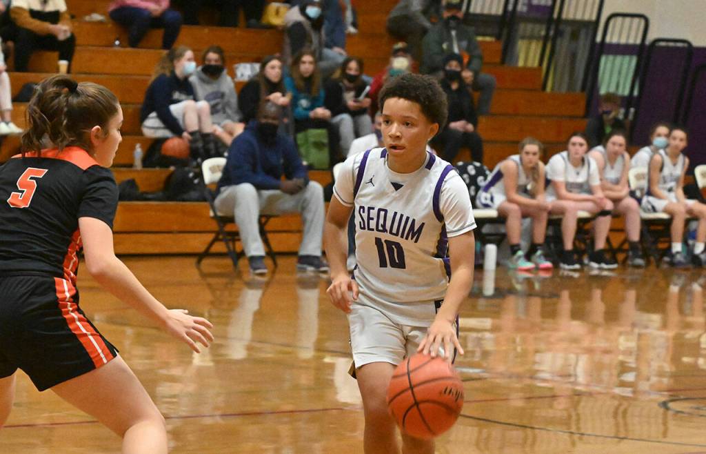 Sequims Bobbie Mixon looks to pass in the Wolves Dec. 13 home match-up with Central Kitsap. The visiting Cougars edged Sequim, 44-42. Sequim Gazette photo by Michael Dashiell