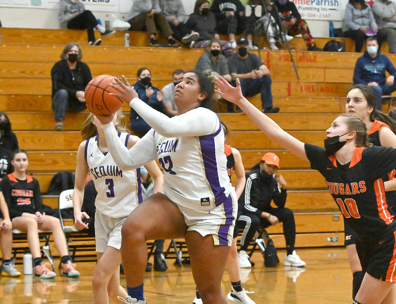 Sequims Jelissa Julmist drives past Central Kitsaps Ella Baungartner for a basket in the Wolves match-up with the Cougars on Dec. 13. Sequim Gazette photo by Michael Dashiell