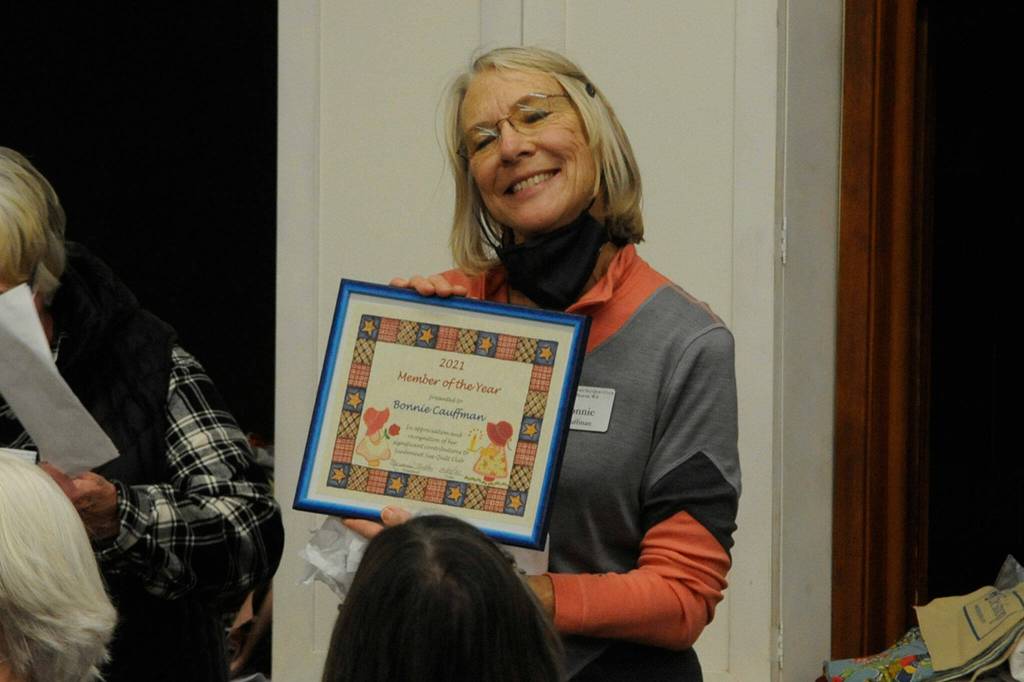 Bonnie Cauffman accepts the Sunbonnet Sue Quilt Clubs Club Member of the Year award during the clubs regular meeting on Dec. 8.