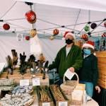Greg and Marilyn Gundy of Sea Basket Farm spruce up for the holidays at the Sequim Farmers & Artisans Market in 2020. Photo by Emma Jane Garcia